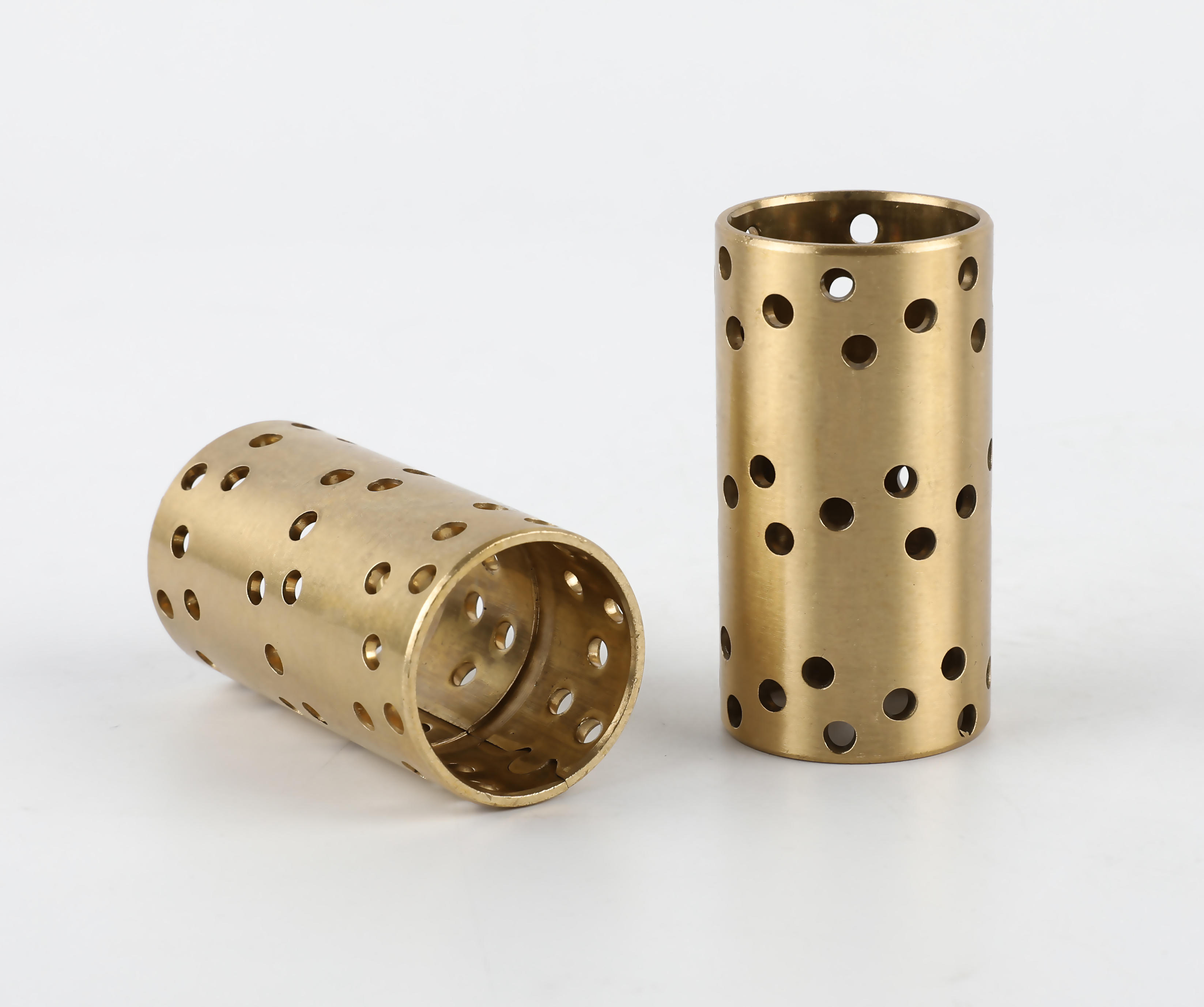 What are the advantages of using brass as a wrapping material for bushing bearings